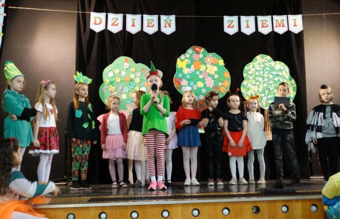 21 kwietnia 2023 roku w naszej szkole odbył się apel poświęcony problematyce segregacji odpadów. Uczniowie z klas drugich i trzecich, a następnie dzieci z grup przedszkolnych, z wielkim zainteresowaniem obejrzeli sztukę o tarapatach w Królestwie Jego  Królewskiej  Mości, Króla Surowca Wtórnego. Niedobrze żyło się poddanym w tym zaśmieconym Królestwie. Ludzie nie dbali o porządek, rzucali zbędne opakowania byle gdzie, szklane butelki zostawiali w lesie, a metalowe puszki w parku pod ławką. Poddani zwrócili się do Króla Surowca Wtórnego o pomoc w rozwiązaniu tego problemu. Rozwiązanie znaleźli  najmłodsi członkowie rodziny królewskiej: Królewicz Surowczyk i Królewna Surówka. Zaproponowali segregację odpadów w królestwie, poprzez ustawienie koszy na ulicach z napisami, co wrzucać do którego kosza. Wszystkim zebranym pomysł się bardzo spodobał .Humorystyczna tematyka apelu uwrażliwiła naszych uczniów na problem segregacji odpadów we własnych rodzinach, możliwości ograniczenia ilości wytwarzanych śmieci oraz dbałości o najbliższe otoczenie.   Aktorami przedstawienia byli uczniowie klas: IA i IB pod kierunkiem wychowawczyń: Danuty Prokop i Ewy Kilian.