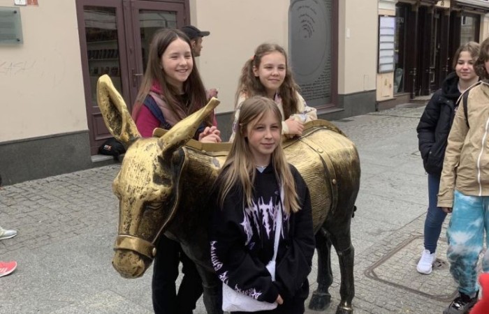 19 maja uczniowie klas 5a i 5b odwiedzili rodzinne miasto Mikołaja Kopernika. Zwiedzanie Torunia rozpoczęliśmy od Krzywej Wieży. Tutaj mogliśmy sprawdzić naszą prawość i uczciwość, gdyż według legendy tylko człowiek bez grzechu może utrzymać równowagę opierając się o jej ścianę. Następnie pan przewodnik oprowadził nas po Starym Mieście. Zobaczyliśmy dom i pomnik Mikołaja Kopernika, podziwialiśmy gotyckie kamienice, Bramę Klasztorną, Ratusz Staromiejski, Katedrę św. Jana Chrzciciela i św. Jana Ewangelisty. Poznaliśmy historię miasta i losy Mikołaja Kopernika. 
Kolejnym punktem programu było Żywe Muzeum Piernika. Pod okiem mistrza Dawida poznaliśmy rytuały związane z wypiekiem piernika. Własnoręcznie przygotowaliśmy ciasto i przy użyciu drewnianych form upiekliśmy pierniczki. Po warsztatach mieliśmy okazję zobaczyć manufakturę z początku XX wieku, maszyny służące do wypieku piernika, zabytkowy piec oraz kolekcję form woskowych.
Ostatnią atrakcją był Dom Legend Toruńskich. Tutaj nie tylko wysłuchaliśmy legend związanych z miastem, ale również sami mogliśmy wcielić się w ich bohaterów.
W drodze powrotnej zajechaliśmy do Grudziądza. Przeszliśmy Bramą Wodną na Stare Miasto i zrobiliśmy pamiątkową fotografię pod pomnikiem ułana i dziewczyny. 
To był udany dzień, pełen wrażeń. 