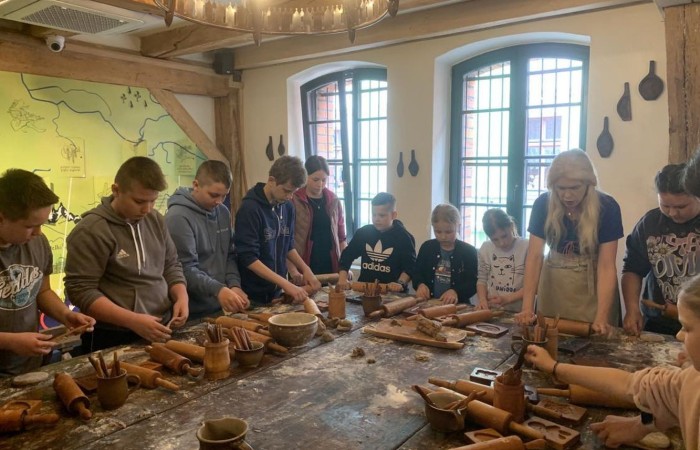 19 maja uczniowie klas 5a i 5b odwiedzili rodzinne miasto Mikołaja Kopernika. Zwiedzanie Torunia rozpoczęliśmy od Krzywej Wieży. Tutaj mogliśmy sprawdzić naszą prawość i uczciwość, gdyż według legendy tylko człowiek bez grzechu może utrzymać równowagę opierając się o jej ścianę. Następnie pan przewodnik oprowadził nas po Starym Mieście. Zobaczyliśmy dom i pomnik Mikołaja Kopernika, podziwialiśmy gotyckie kamienice, Bramę Klasztorną, Ratusz Staromiejski, Katedrę św. Jana Chrzciciela i św. Jana Ewangelisty. Poznaliśmy historię miasta i losy Mikołaja Kopernika. 
Kolejnym punktem programu było Żywe Muzeum Piernika. Pod okiem mistrza Dawida poznaliśmy rytuały związane z wypiekiem piernika. Własnoręcznie przygotowaliśmy ciasto i przy użyciu drewnianych form upiekliśmy pierniczki. Po warsztatach mieliśmy okazję zobaczyć manufakturę z początku XX wieku, maszyny służące do wypieku piernika, zabytkowy piec oraz kolekcję form woskowych.
Ostatnią atrakcją był Dom Legend Toruńskich. Tutaj nie tylko wysłuchaliśmy legend związanych z miastem, ale również sami mogliśmy wcielić się w ich bohaterów.
W drodze powrotnej zajechaliśmy do Grudziądza. Przeszliśmy Bramą Wodną na Stare Miasto i zrobiliśmy pamiątkową fotografię pod pomnikiem ułana i dziewczyny. 
To był udany dzień, pełen wrażeń. 