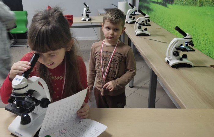 26 lutego w naszej szkole odbył się wyjątkowy DZIEŃ OTWARTY, podczas którego mieliśmy przyjemność gościć przedszkolaków, przyszłych uczniów oraz ich rodziców. Była to doskonała okazja, aby poczuć atmosferę naszej szkoły, poznać jej ofertę edukacyjną i odkryć to, co czyni ją miejscem pełnym pasji, wiedzy i radości.
Zwiedzanie naszej placówki obejmowało sale przedmiotowe, bibliotekę, stołówkę, świetlicę oraz małą salę gimnastyczną, gdzie można było na własnej skórze poczuć rytm codziennego życia naszej szkolnej społeczności.
Na odwiedzających czekało mnóstwo niespodzianek! Zachętą do działania były pieczątki, które najmłodsi otrzymywali w nagrodę za wykonanie przeróżnych zadań. W sali gimnastycznej na uczestników czekały ekscytujące konkurencje sprawnościowe, a w pracowni kulinarnej – pachnące i chrupiące gofry własnej roboty. Młodzi odkrywcy mieli okazję badać świat przez mikroskop, eksperymentować z interaktywnymi robotami Photon oraz brać udział w zajęciach z robotyki. Z kolei miłośnicy sztuki mogli tworzyć piękne dzieła na warsztatach plastycznych i origami, a najmłodsi cieszyli się malowaniem twarzy.
Nie zabrakło także wyzwań dla bystrego umysłu! Gry i zabawy językowe, rebusy oraz polonistyczne łamigłówki rozbudzały wyobraźnię i rozwijały umiejętności językowe. Wesoła „Gimnastyka buzi i języka” sprawiła, że ćwiczenie dykcji stało się czystą przyjemnością. Ogromnym zainteresowaniem cieszyły się również gry planszowe, które dostarczyły mnóstwa radości i emocjonującej rywalizacji. Dodatkowo, zabawy z chustą Klanza okazały się świetnym sposobem na integrację i wspólną zabawę pełną śmiechu.
Aktywne zwiedzanie stało się więc okazją do rozwijania ciekawości świata, nabywania nowych umiejętności, pobudzania w najmłodszych kreatywności oraz odczuwania satysfakcji z osiągniętego sukcesu.