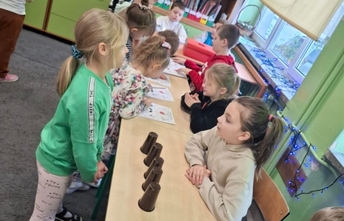 W tym roku Andrzejki w naszej szkole były pełne magii, radości i uśmiechu. Uczniowie klas trzecich przygotowali dla pierwszaków wyjątkowe wróżby i zabawy, dzięki którym mali uczestnicy mogli poczuć prawdziwą andrzejkową atmosferę. Nie zabrakło tradycyjnych wróżb, takich jak serca z imionami, magiczne kubeczki czy karty, a także mnóstwa śmiechu i wspólnej zabawy. Było kolorowo, wesoło i… trochę tajemniczo.
Serdeczne podziękowania dla naszych starszych uczniów za kreatywność i świetną zabawę, a także dla pierwszaków za aktywny udział w andrzejkowych atrakcjach. To był naprawdę magiczny dzień.